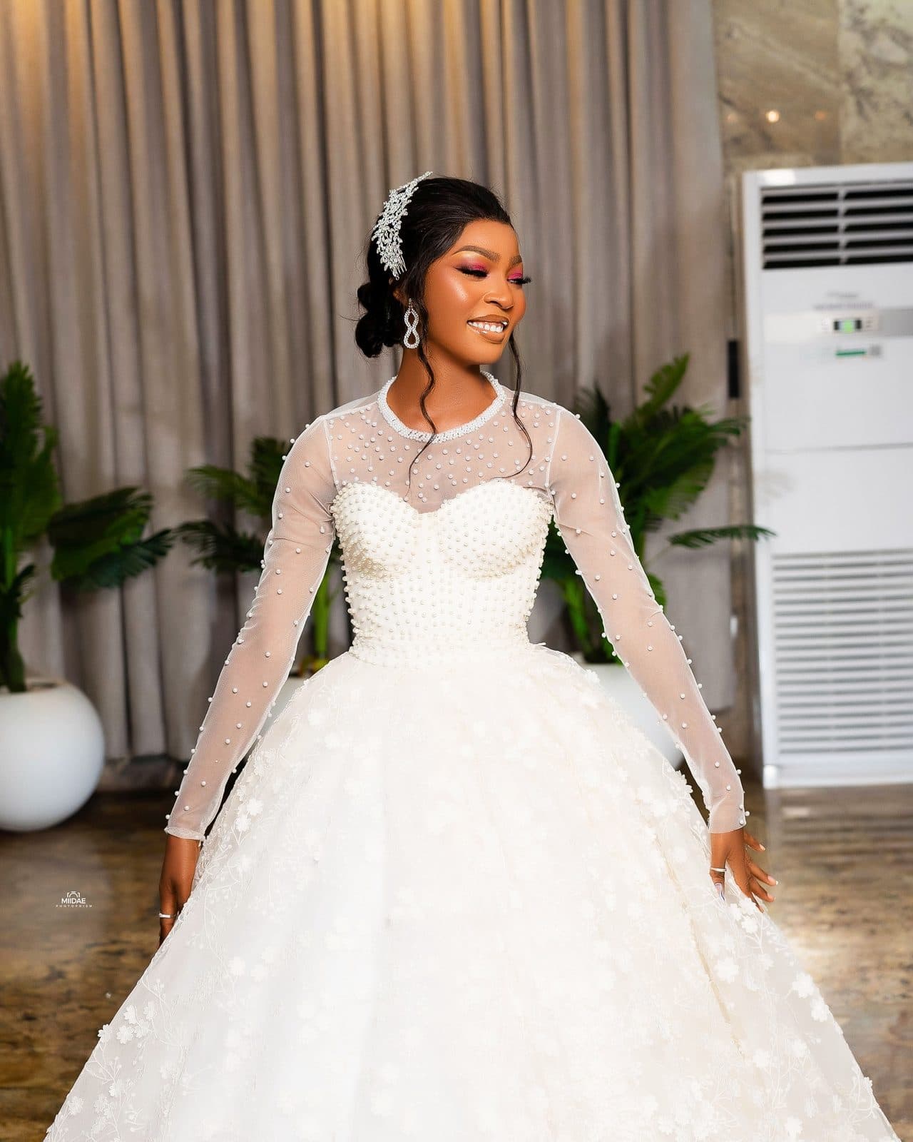 A student's final project: a white ball gown with long lace sleeves